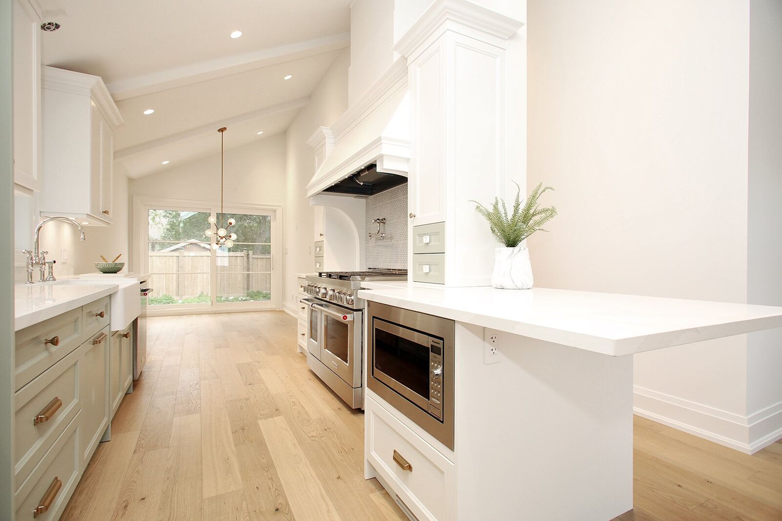 Bright vaulted-ceiling kitchen with a large farmhouse range, Country Charm Sage renovation in Alderwood